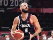  ?? Eric Gay / Associated Press ?? France’s Evan Fournier (10) handles the ball during an Olympic quarterfin­al win over Italy on Tuesday. Fournier agreed to a 4-year, $78 million deal with the Knicks.