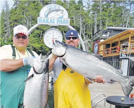  ?? FAMILY PHOTO VIA FACEBOOK ?? Steven Price, 72, left, and his son, Doug, are shown hoisting their catches on a dock at Ole’s Hakai Pass Fishing Lodge in 2013. Steven Price died last week after a float plane carrying the pair crashed on Addenbroke Island, about 100 kilometres north of Port Hardy. The pair were headed to the lodge for an annual trip. Doug Price suffered serious injuries to his legs.