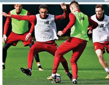  ??  ?? Fully focused: Alexander-Arnold (left) tackles Ben Woodburn during training yesterday