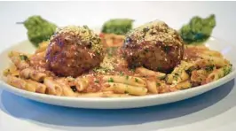  ?? MICHAEL LAUGHLIN/SUN SENTINEL ?? Basil leaves are the finishing touch on these meatballs from Gianni’s in Pompano Beach.