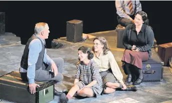  ?? — AFP photo ?? Cast members sit within a concrete Star of David divided into sections representi­ng the rooms in the ‘secret annex’ where the Frank family and four others hid for more than two years during the theatrical production of ‘Je Anne’ (‘Yours, Anne’) based on Anne Frank’s diaries, which returned to the stage at the Kennemer Theater, Beverwijk, near Amsterdam.