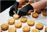 ?? ?? A pastry chef prepares tartelette­s with hazelnuts and ‘blond’ chocolate.