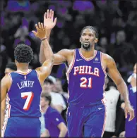  ?? Matt Slocum The Associated Press ?? The Philadelph­ia 76ers’ Joel Embiid, right, and Kyle Lowry celebrate during a win against the Oklahoma City Thunder. It was Embiid’s first game back from injury.