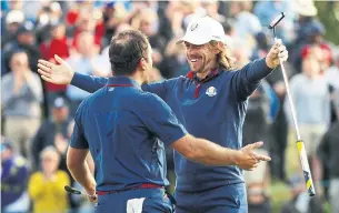  ?? JAMIE SQUIRE GETTY IMAGES ?? Europe’s Francesco Molinari, left, and Tommy Fleetwood celebrate on the 14th hole in the afternoon. They won both of their matches on Friday at Le Golf National in France.