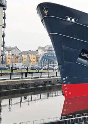  ??  ?? The Very Rev Dr Angus Morrison beside the Fingal, a former Northern Lighthouse Board tender transforme­d into a luxury hotel moored in Edinburgh.