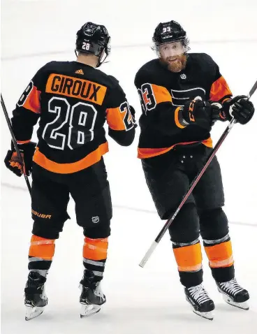  ?? — THE ASSOCIATED PRESS FILES ?? Philadelph­ia Flyers’ Jakub Voracek, right, celebratin­g here with Claude Giroux, arrives in Calgary on a five-game tear. The 29-year-old has scored three times and added a hat trick of helpers during this stretch.