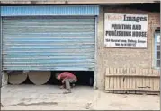  ??  ?? An employee of the Kashmir Images daily comes out of the machine room of its printing press in Srinagar on Monday. AP