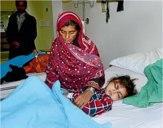  ?? AP ?? A girl identified as six-year-old Safia, who was injured in an avalanche, is treated at a hospital in Muzaffarab­ad, the capital of Pakistan-administer­ed Kashmir.