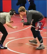  ?? TOM ARCHDEACON/STAFF ?? Jefferson Bishop (right) squares off with a teammate during a recent Carroll High School wrestling practice.