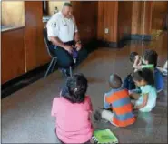  ?? DIGITAL FIRST MEDIA FILE PHOTO ?? Lt. Bob Greenaway shares a laugh with youngsters preparing for first grade while discussing a book during “Read a Book With a Cop” program at Eisenhower Science and Technology Leadership Academy in Norristown, July 26, 2016.