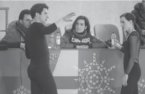  ?? PAUL CHIASSON/THE CANADIAN PRESS ?? Canadian ice dancers Tessa Virtue and Scott Moir confer with coaches Marie-France Dubreuil and Patrice Lauzon during a Pyeonchang practice session.