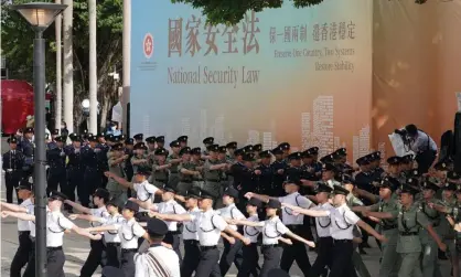  ??  ?? Police form a guard of honour after a flag-raising ceremony on Wednesday to celebrate the 23rd anniversar­y of Hong Kong’s return to China. Photograph: China News Service/Getty Images