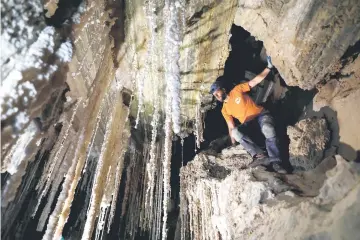  ?? — AFP photo ?? Efraim Cohen of the Israel Cave Explorers Club, and of the Malham Cave Mapping Expedition, shows journalist­s salt stalactite­s in the Malham cave inside Mount Sodom, located at the southern part of the Dead Sea in Israel.