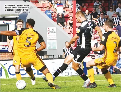  ?? PICTURE: PSI/Ian Lyall ?? INFLUENTIA­L: Striker James Hanson scores in Grimsby’s 5-2 romp against Port Vale