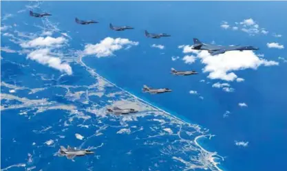  ??  ?? This handout photo taken on September 18, 2017 and provided by the South Korean Defence Ministry in Seoul shows a US Air Force B-1B Lancer bomber (R), US F-35B stealth jet fighters (bottom) and South Korean F-15K fighter jets (top) flying over South...