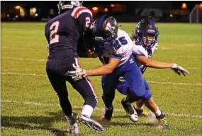  ?? BILL RUDICK — DIGITAL FIRST MEDIA ?? Kennett’s Danny Mancini (25) and Xavier Feliciano stop Octorara’s Zac Heagy on Friday.