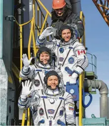  ?? NASA / Getty Images ?? NASA’s Anne McClain, second from bottom, was among a crew that landed at the Internatio­nal Space Station on Monday.