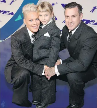  ?? PHILLIP FARAONE/GETTY IMAGES ?? Pink, left, Willow Sage Hart and Carey Hart wore matching suits to the MTV Video Music Awards. Pink spoke about beauty and applied it to her six-year-old’s concerns about appearance.
