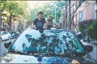  ??  ?? Journalist Mark Kennedy poses with his kids popping out of the sunroof of his first car, a 2015 Mazda CX-5, in the Brooklyn borough of New York. The pandemic has altered so much in America in ways great and small. The subways, buses and ride-sharing platforms are trips not for the nervous and car-sharing services aren’t practical or economical for long-term rentals. (Courtesy Photo/Lisa Tolin)