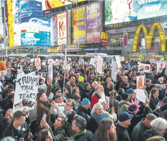  ??  ?? People attend a protest in Times Square the day after President Donald Trump forced the resignatio­n of Attorney General Jeff Sessions, New York City, Nov. 8.