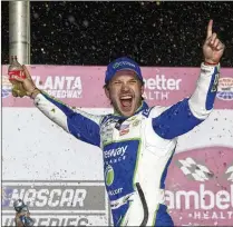  ?? JASON GETZ/JASON.GETZ@AJC.COM ?? Daniel Suarez celebrates in victory lane after winning the Ambetter Health 400 NASCAR race at the Atlanta Motor Speedway on Sunday in Hampton.