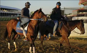  ?? AP ?? SECOND LEG: Epicenter, left, the runner up in the Kentucky Derby, leaves the track after a workout ahead of the Preakness Stakes at Pimlico Race Course on Wednesday.