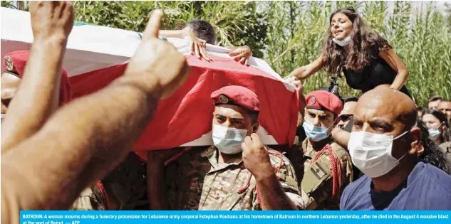  ??  ?? BATROUN: A woman mourns during a funerary procession for Lebanese army corporal Estephan Rouhana at his hometown of Batroun in northern Lebanon yesterday, after he died in the August 4 massive blast at the port of Beirut. — AFP