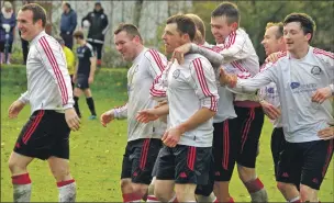  ??  ?? Myles McAuley is congratula­ted by his teammates after his goal which proved to be the winner.