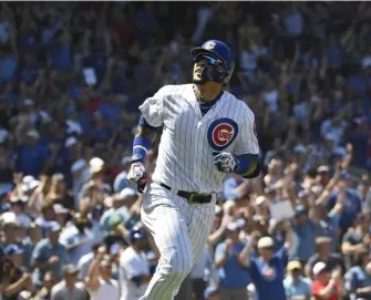  ?? ASSOCIATED PRESS ?? THINGS ARE LOOKING UP: Javier Baez reacts as he runs the bases on his two-run home run in the Cubs’ 6-2 victory against the Brewers yesterday in Chicago.