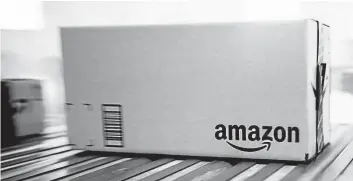  ?? BLOOMBERG ?? Boxes move along a conveyor belt at the Amazon.com Inc. fulfillmen­t center .