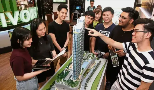  ??  ?? Visitors checking out a model on display at the Ivory Properties Group Bhd booth during the StarProper­ty. my Fair 2017 at Gurney Plaza.