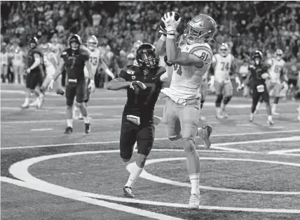  ??  ?? Matt Lynch, who began his UCLA career as a quarterbac­k from Legacy High School in Broomfield, catches a touchdown as a tight end over Arizona cornerback Jace Whittaker last fall in Tucson. Lynch is now at CU.