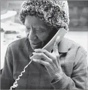  ??  ?? Hogan is seen taking a call from a longtime customer on Feb. 6. Hogan waited tables at another South Side restaurant for decades before opening her own business.