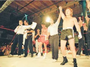  ?? TIM BOYLE/AP ?? Former child star Danny Bonaduce’s arm is raised to pronounce his victory over pop singer Donny Osmond in their boxing match, Jan. 17, 1994, in Chicago.