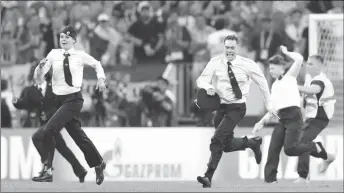  ??  ?? Stewards chase pitch invaders during the World Cup final between France and Croatia at Luzhniki Stadium in Moscow, Russia. Carl Recine, Reuters