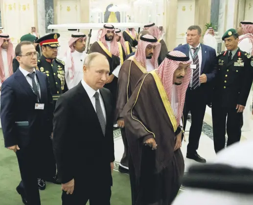  ??  ?? Russian President Vladimir Putin (2nd L) and Saudi King Salman (C) arrive for talks in Riyadh, Saudi Arabia, Oct. 14, 2019.