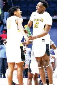  ??  ?? Starkville High School’s Coltie Young (12) and Trey Jackson celebrate at the end of Saturday night’s 58-51 win over Murrah to win the state championsh­ip. (Photo by Keith Warren, MHSAA, for Starkville Daily News)