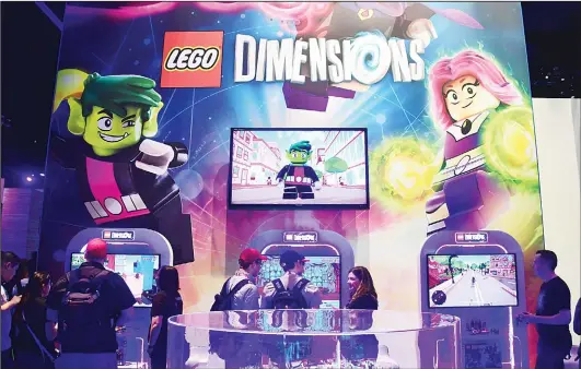  ??  ?? Gaming fans play ‘Lego Dimensions’ on day two of E3 2017, the three-day Electronic Entertainm­ent Expo at the Los Angeles Convention Center in Los Angeles, California on June 14. (AFP)