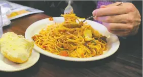  ?? WILLIAM WEST/ AFP/GETTY IMAGES ?? Pasta is fine to eat for people trying to shed pounds if it's served with plenty of vegetables and a protein.