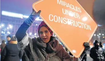  ?? /AFP Photo ?? Rally drivers: People protest against the government in Bucharest, Romania, over corruption legislatio­n. The government repealed the law on Sunday, but protests are continuing across the country, with marchers vowing to continue until the government steps down.