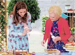  ??  ?? Mary inspects the Duchess of Cambridge’s efforts at icing cupcakes