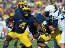  ?? AP PHOTO ?? Michigan running back De’Veon Smith (4) tries to rush by Penn State linebacker Jake Cooper.