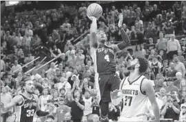  ?? Eric Gay Associated Press ?? SPURS guard Devonte’ Graham scores the winner over Denver guard Jamal Murray on Friday, creating a three-team tie atop the Western Conference