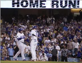  ?? MARK J. TERRILL – THE ASSOCIATED PRESS ?? The Dodgers’ Max Muncy, left, is congratula­ted by Justin Turner after hitting a solo home run during the third inning of Tuesday night’s game against the Twins at Dodger Stadium.