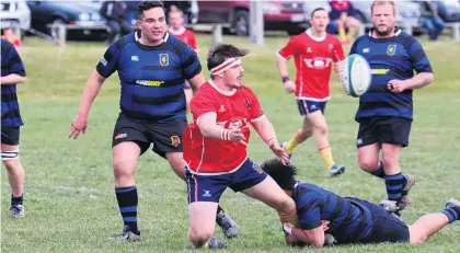  ?? PHOTO: TIM MEEHAN ?? Popping the pass . . . Kurow prop Tom Furnival offloads in the tackle during a Citizens Shield game against Excelsior at Kurow earlier this month.