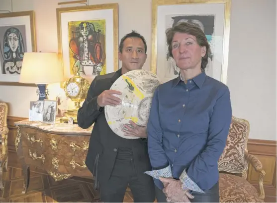  ?? BORIS HEGER/AP ?? Marina Picasso, granddaugh­ter of artist Pablo Picasso, and her son Florian Picasso pose with a ceramic art-work of Pablo Picasso in Cologny near in Geneva, Switzerlan­d, last week. The pair told The Associated Press that they planned to sell 1,010 digital art pieces of one of his ceramic works that has never before seen publicly.