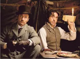  ?? Daniel Smith
Warner Bros. ?? JUDE LAW, left, may be changing the popular conception of Dr. John Watson with the recent blockbuste­rs starring Robert Downey Jr. as Sherlock Holmes.