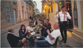  ?? RAMONESPIN­OSA/AP ?? Patrons fill the outdoor area of a private Havana restaurant last January.