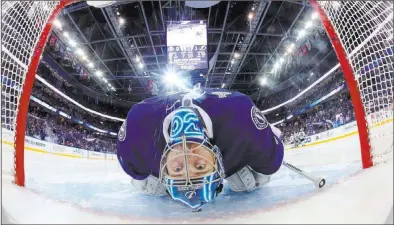  ?? BruCE BENNEtt/ USA TODAY ?? Tampa Bay Lightning goalie Ben Bishop leans back to stretch before the Stanley Cup Finals opener at Amalie Arena.