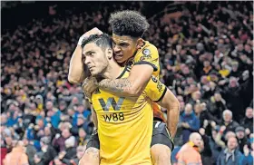  ??  ?? Golden touches: Diego Jota (above) celebrates his winning goal; Morgan Gibbs-white (left) leaps on Raul Jimenez after the Wolves equaliser